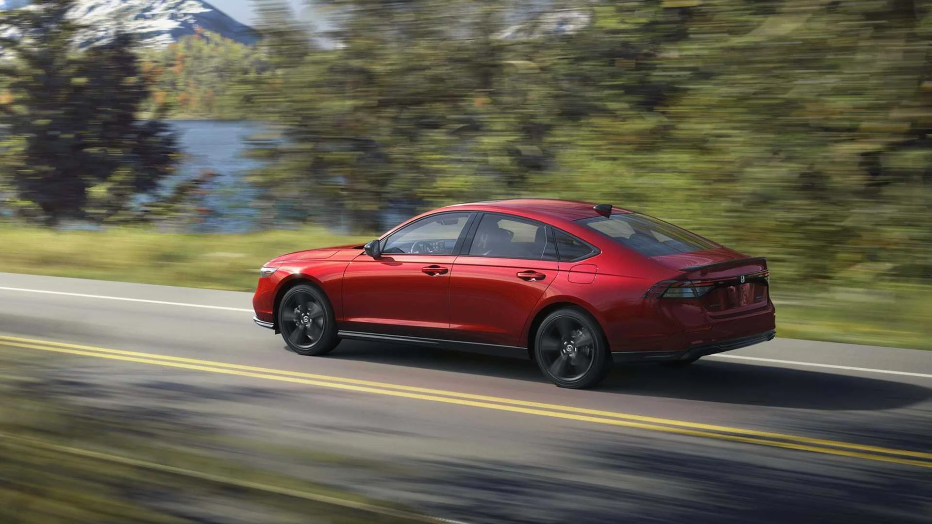Dynamic rear 3/4 shot of a red 2026 Honda Accord Sport L Hybrid.