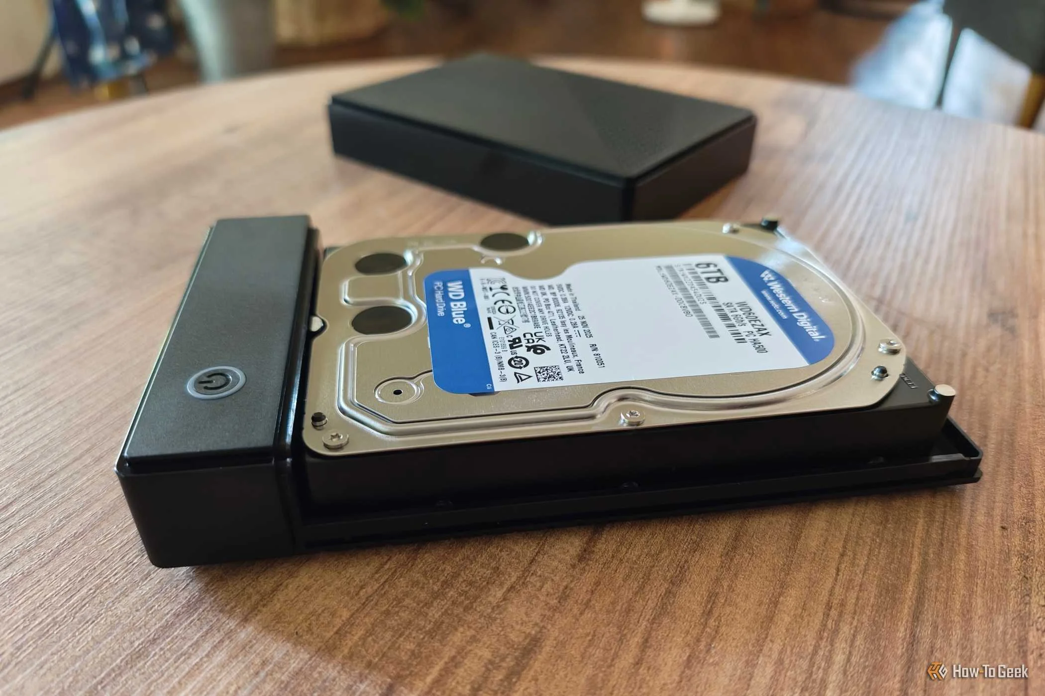 A 6 TB hard disk drive inside of an enclosure on top of a side table. 