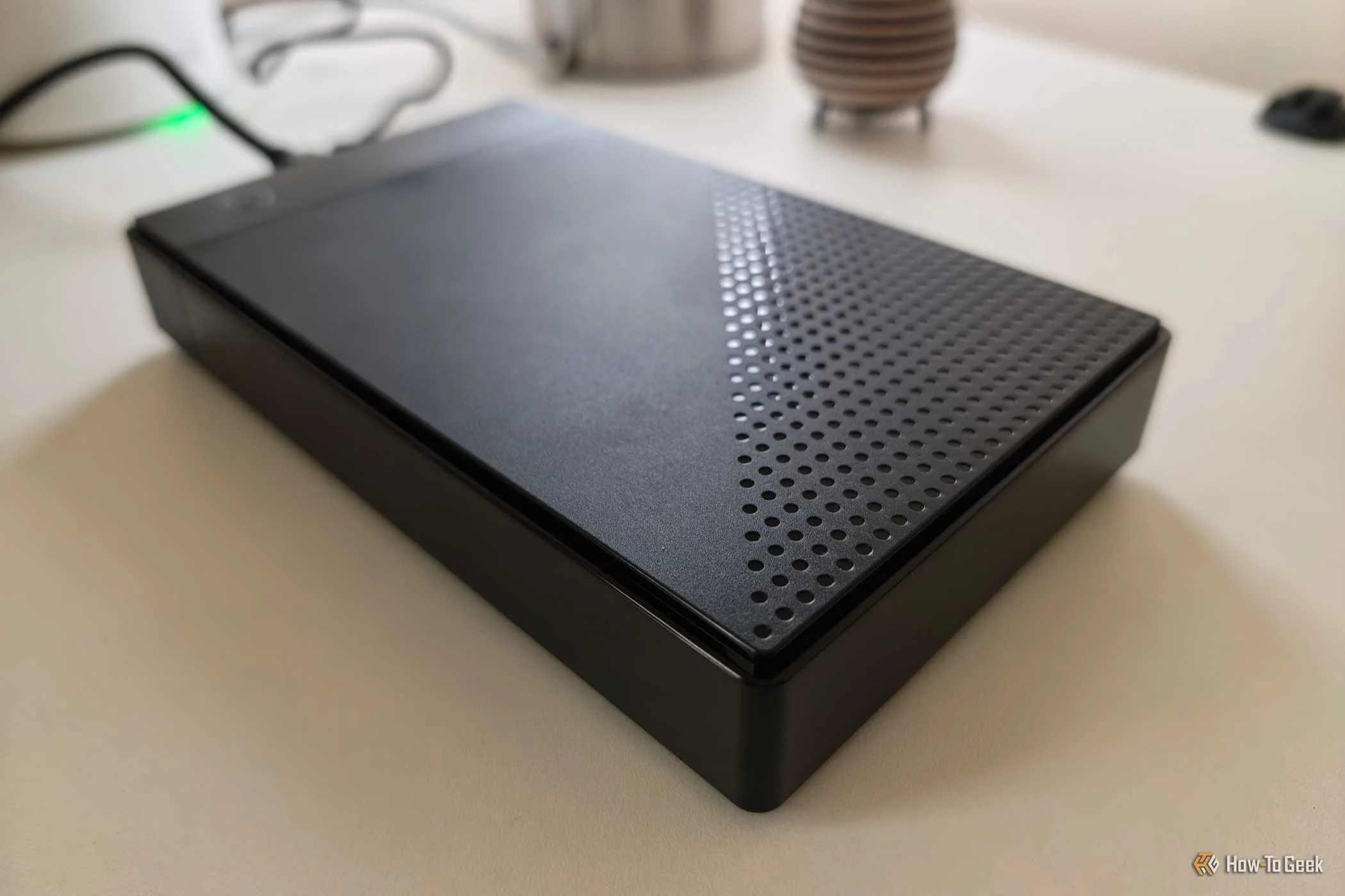 A hard disk drive enclosure on a white office desk. 