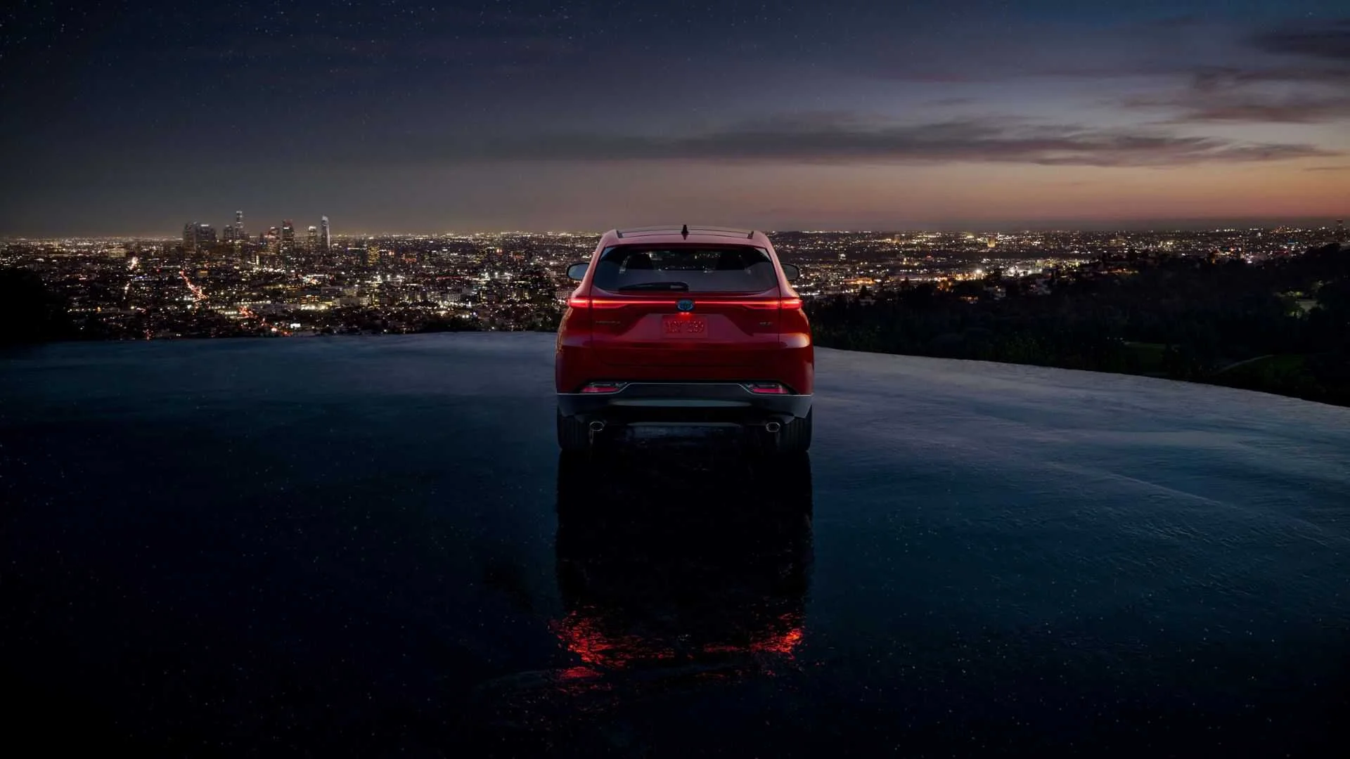 Static rear-end shot of a red 2024 Toyota Venza Nightshade.