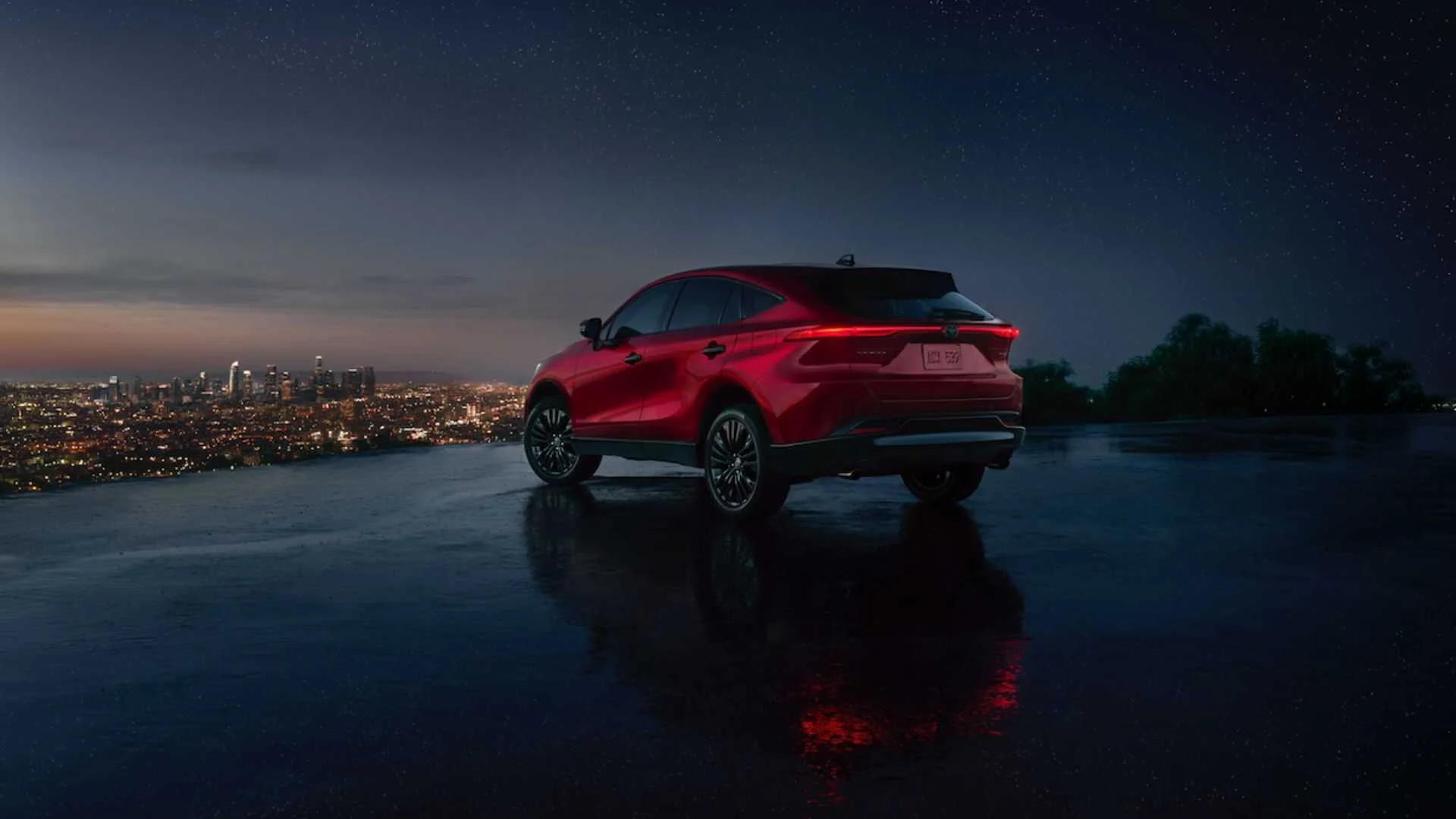 Static rear 3/4 shot of a red 2024 Toyota Venza Nightshade.