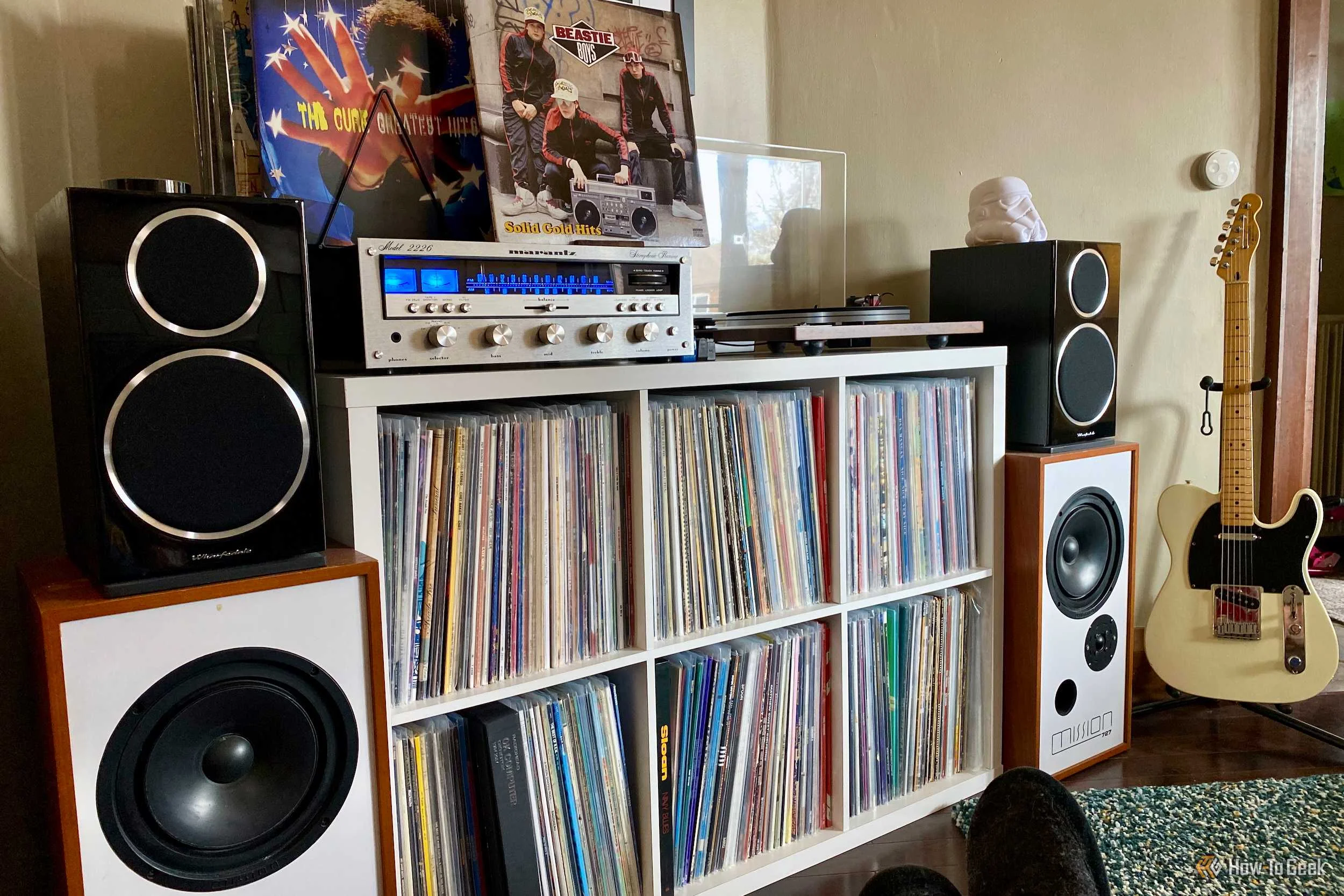A Vinyl Record Setup with a Receiver, Tuturntable, Speakers, and Storage.