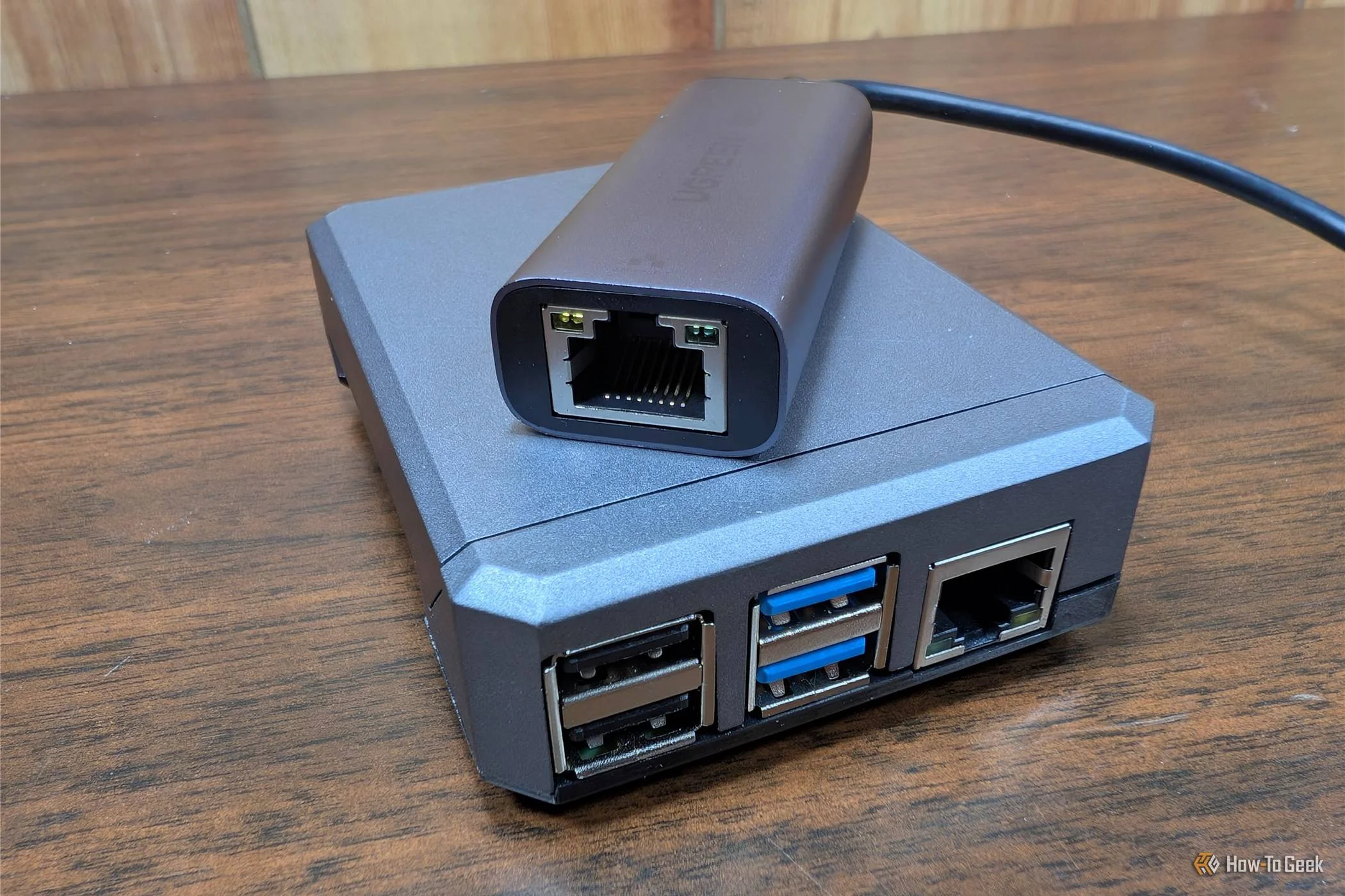 A USB Ethernet adapter on top of a Raspberry Pi 4. 