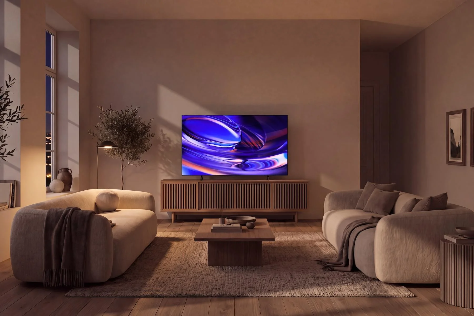 The Sony Bravia 6 OLED TV on a table in a living room at night.