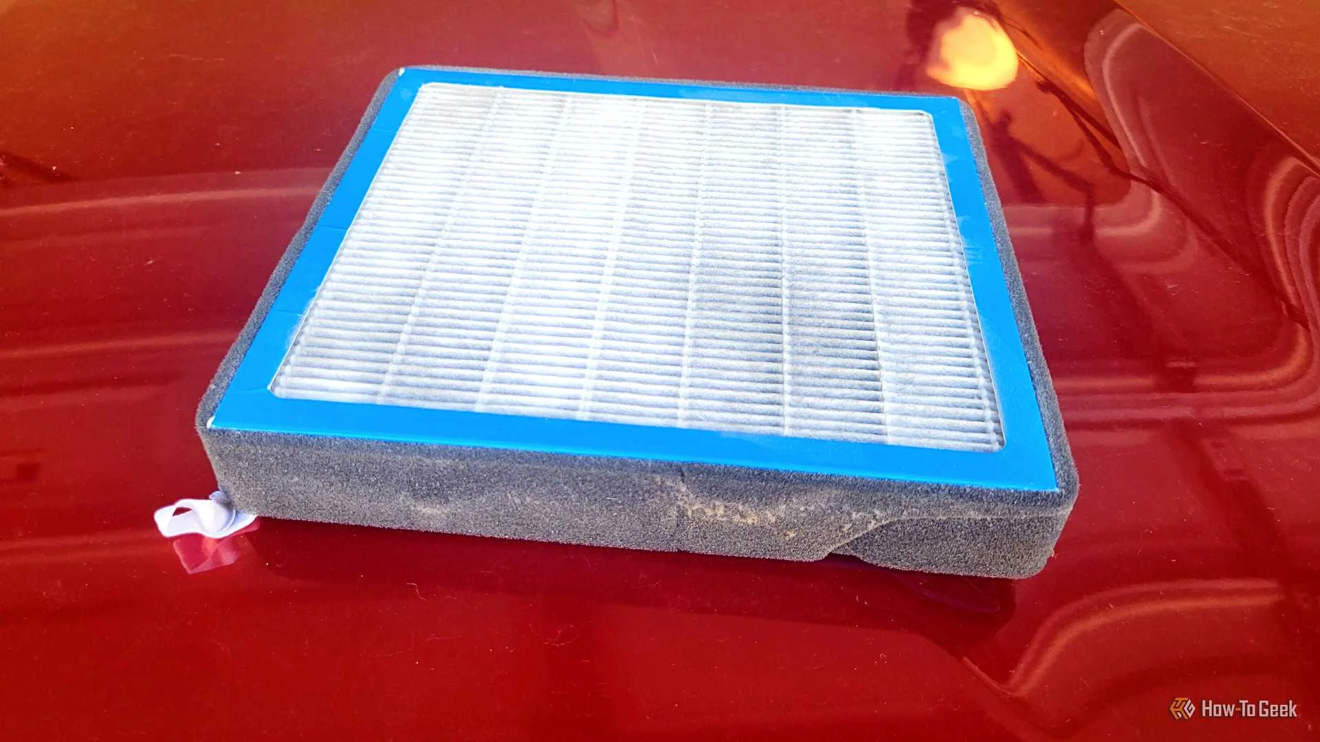 A cabin filter on a hood with the filter side up