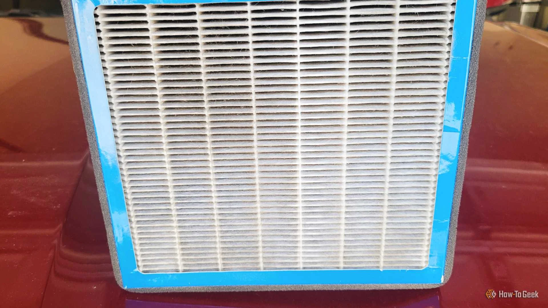 A cabin filter on the hood of a car showing the filter