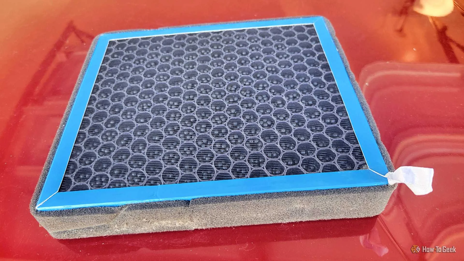 A cabin filter on the hood of a car with the balls up
