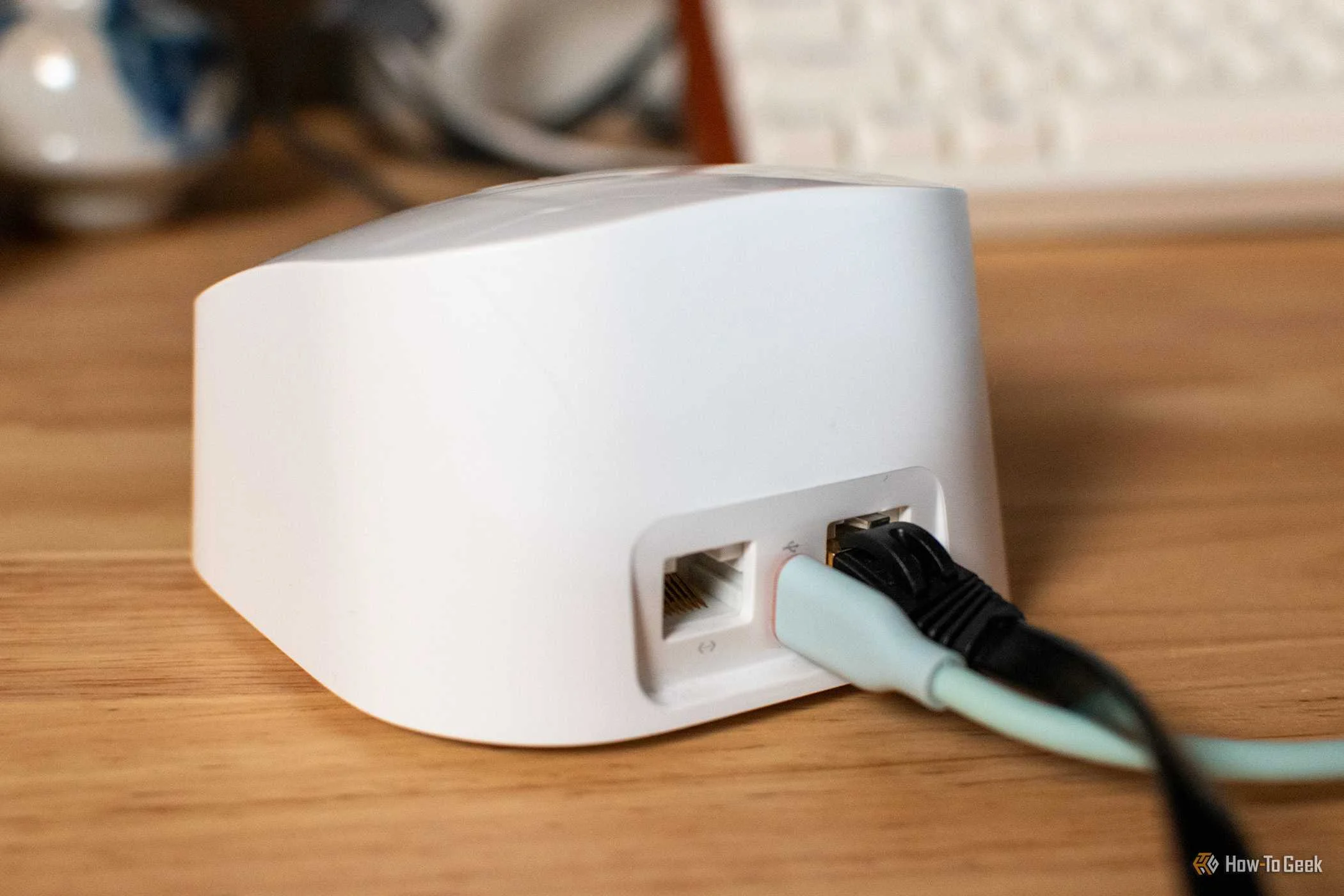 Rear view of Amazon Eero router with USB-C and Ethernet plugged in.