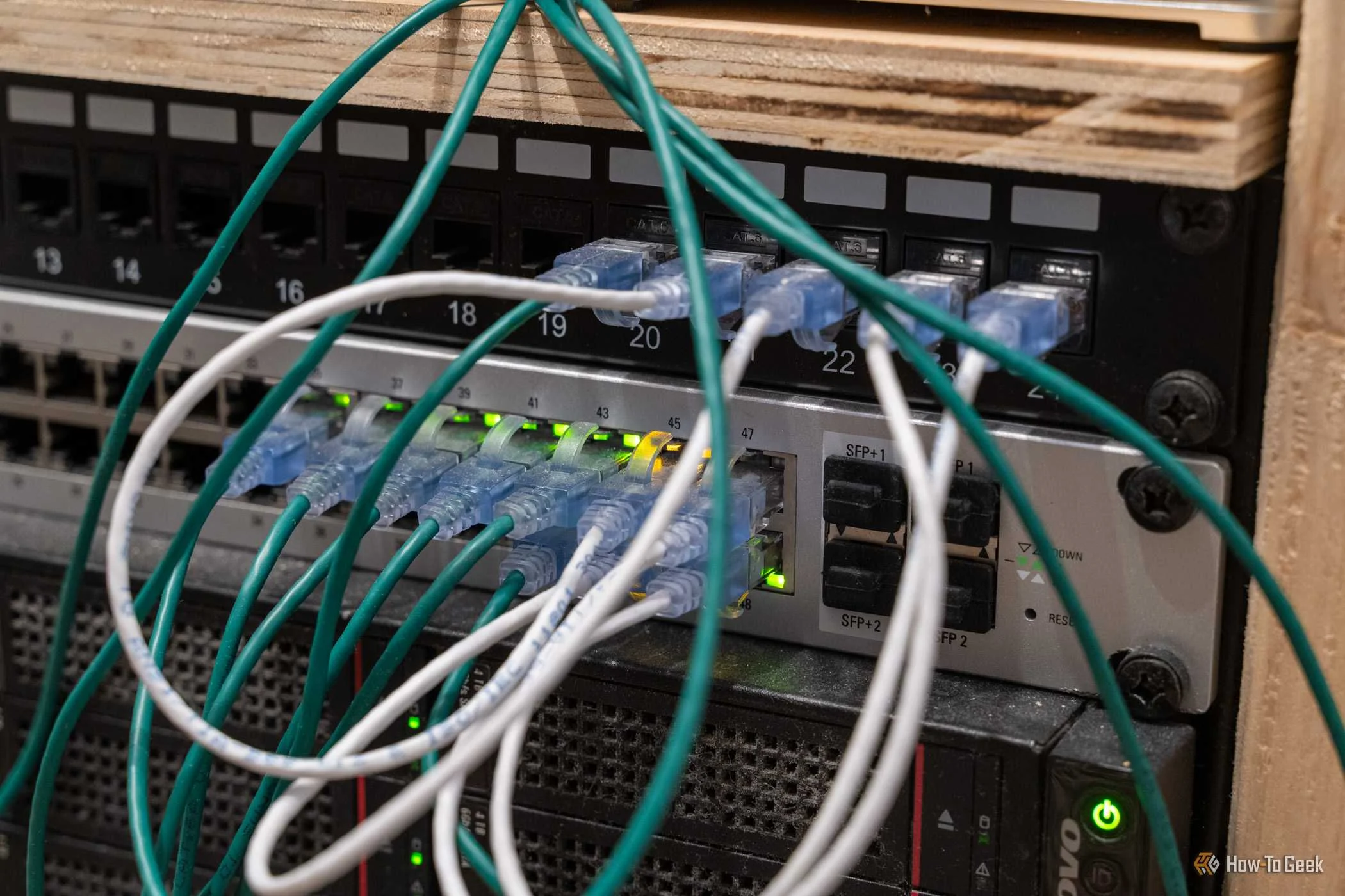 UniFi US-48-500W managed PoE network switch with Ethernet cables and SFP ports.