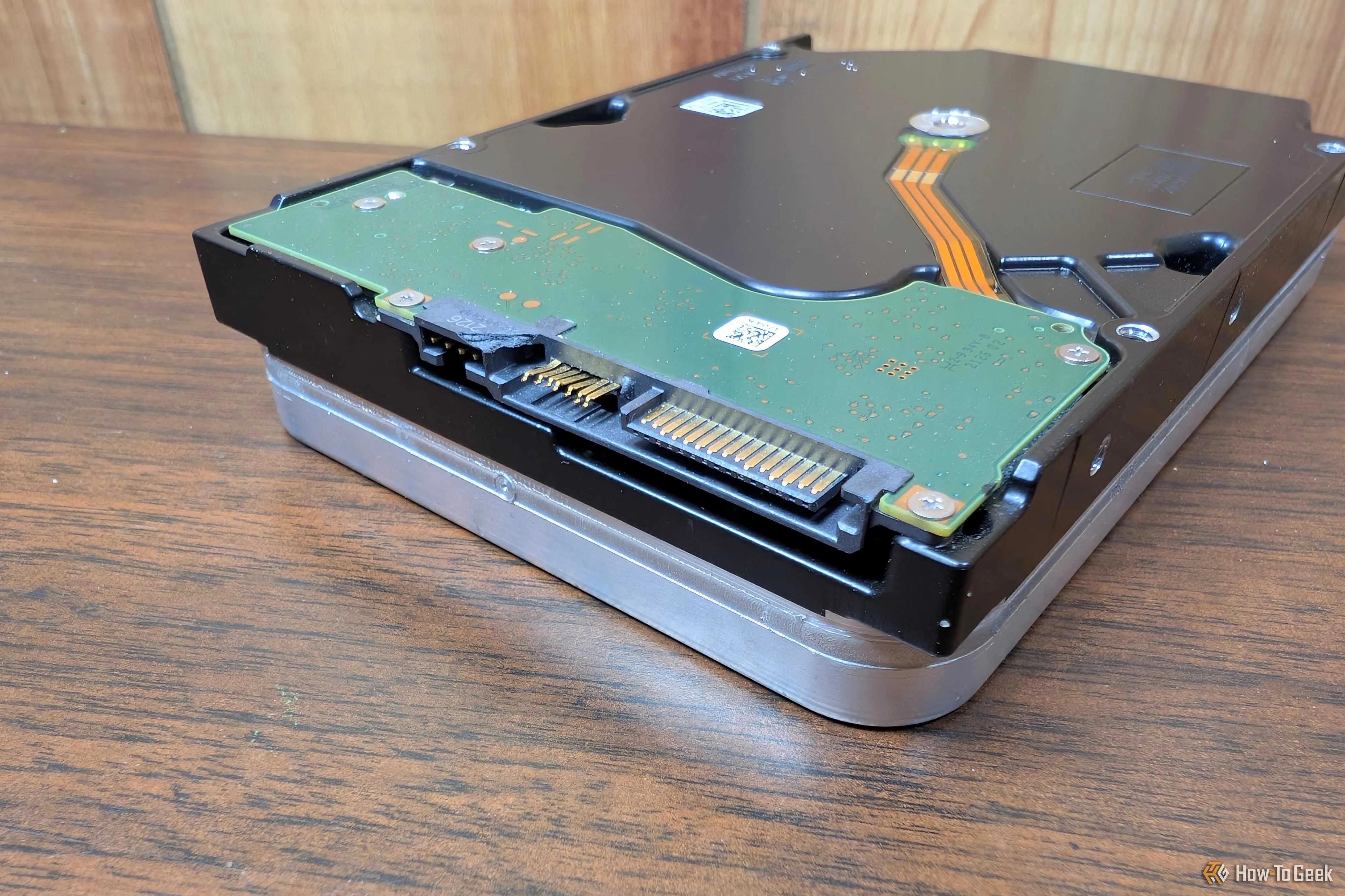 A mechanical hard drive with a busted SATA connector. 