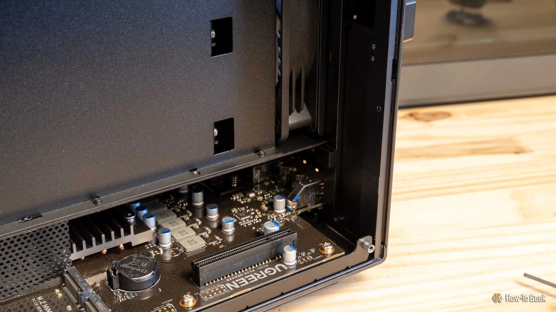 The right side of the Ugreen iDX6011 Pro NAS interior showing PCIe connectors and the motherboard edge.