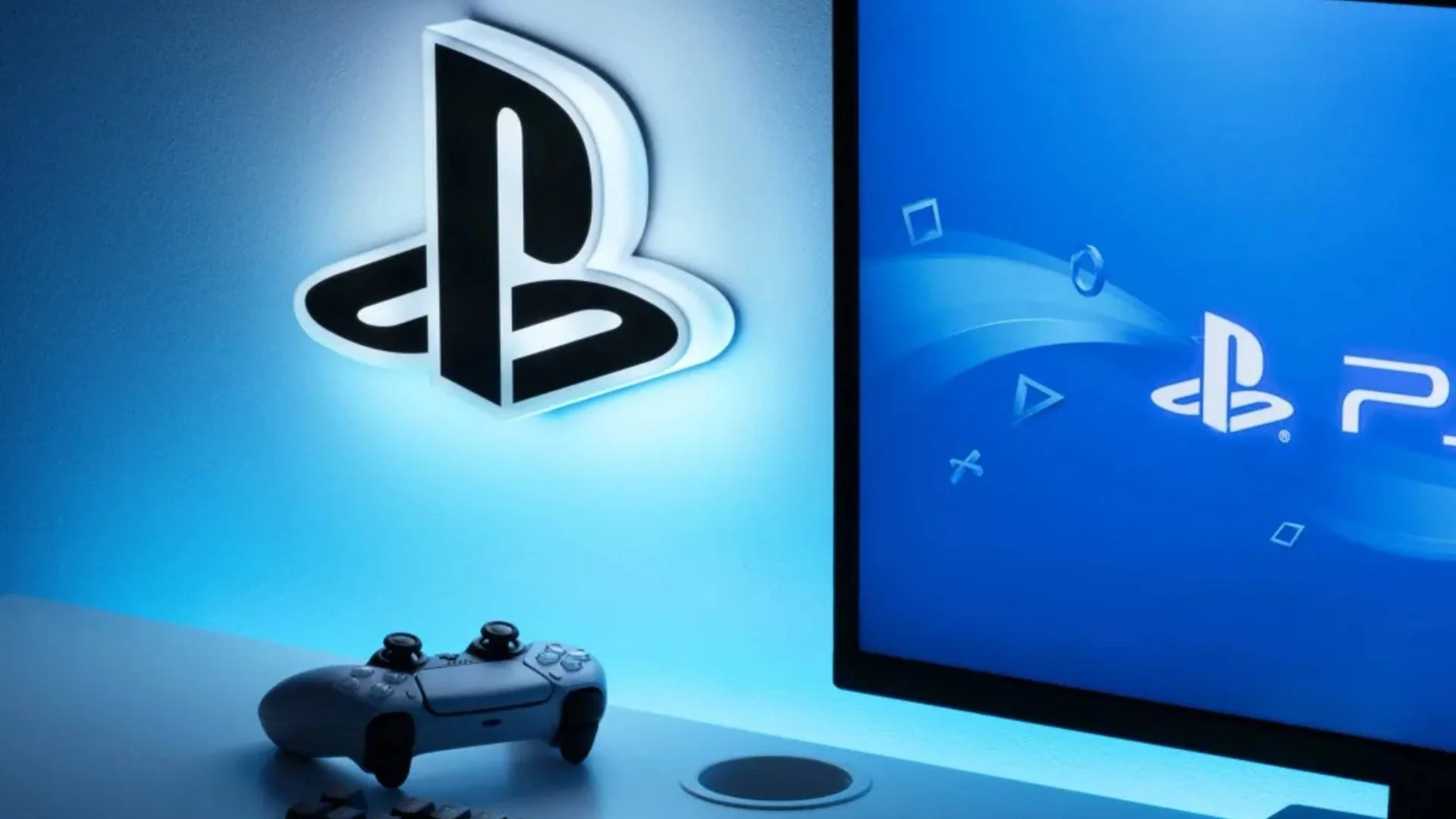 PlayStation Logo on wall next to PS5 Controller and screen with PS5 Logo