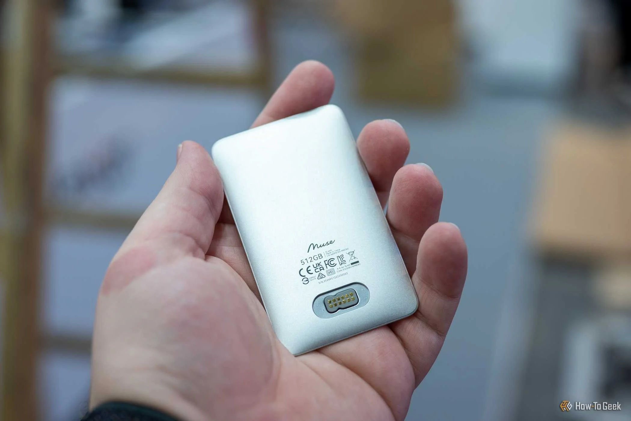 Person holding the Lexar Muse SSD showing the custom connector at IFA 2026.