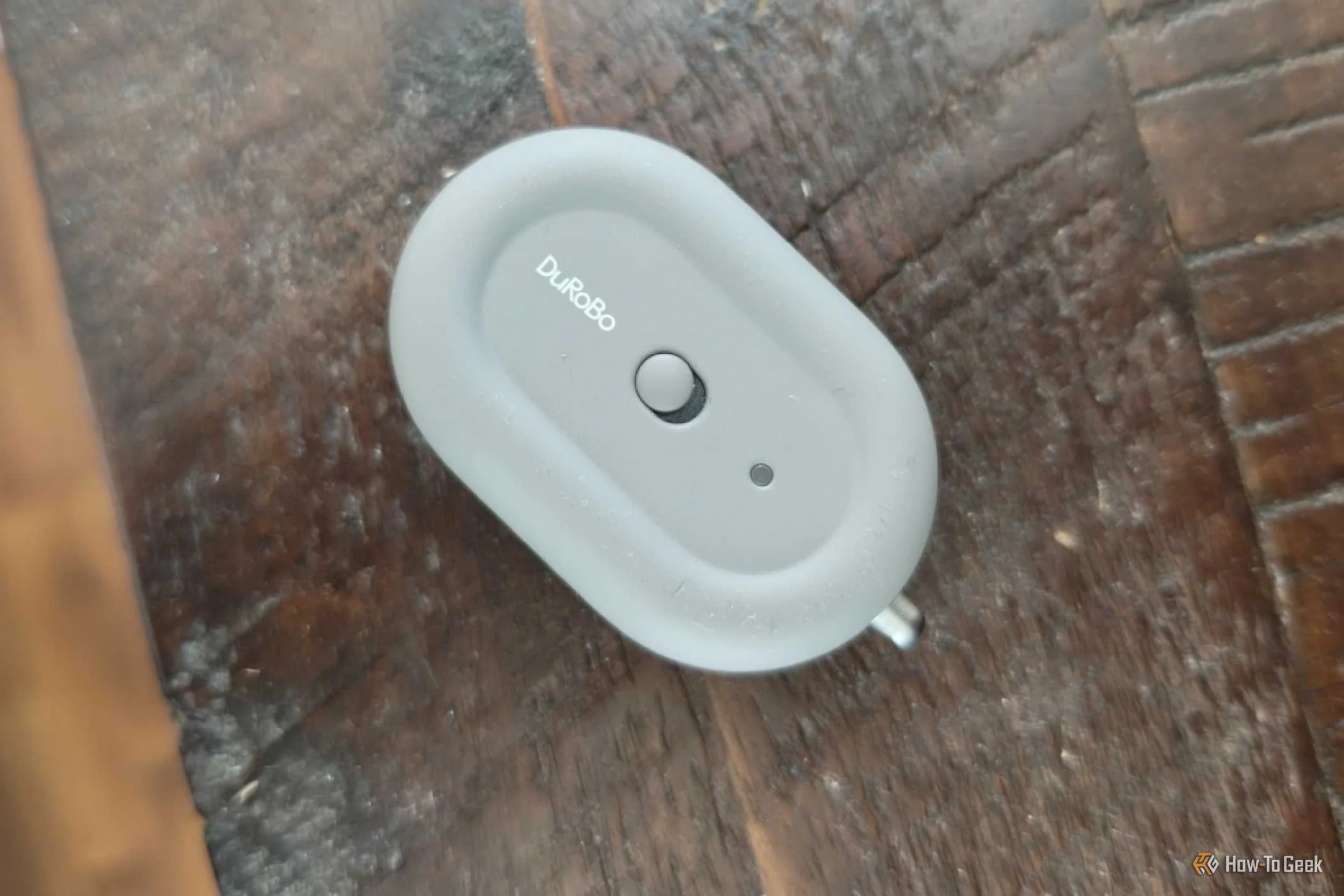 Back of a DuRoBo Moodi Bluetooth page turner near the edge of a wooden shelf.