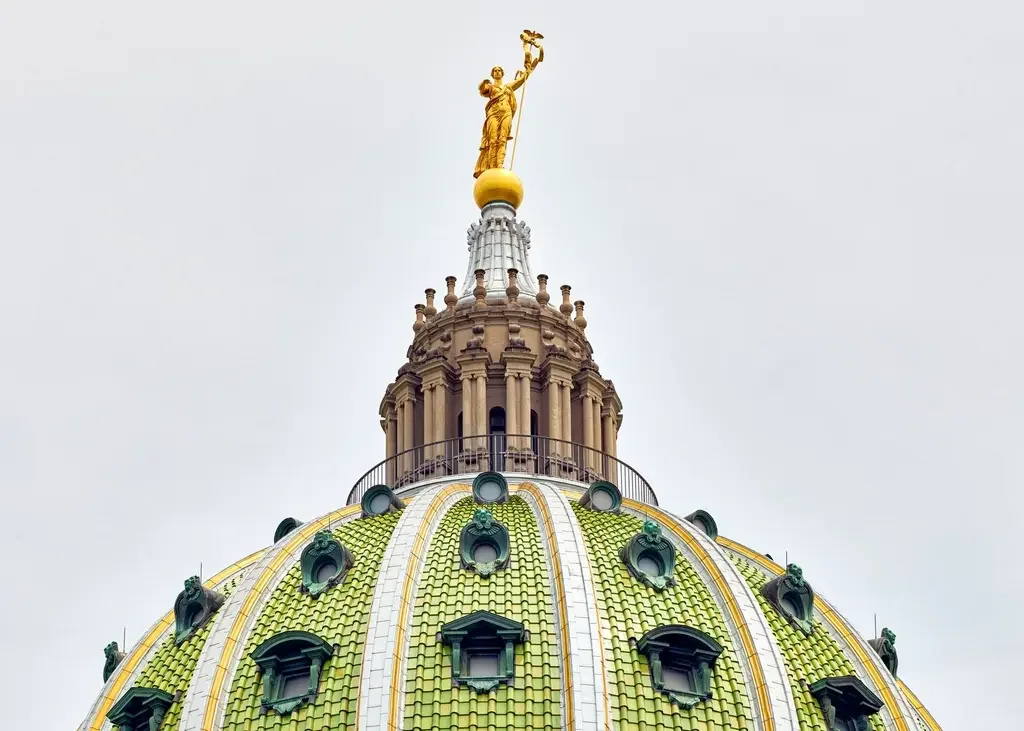 The ornate green tiled dome and golden statue atop the Pennsylvania State Capitol in Harrisburg