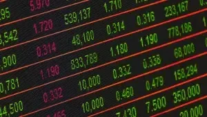 A close-up view of a financial trading screen with green and red numerical data on a black background.