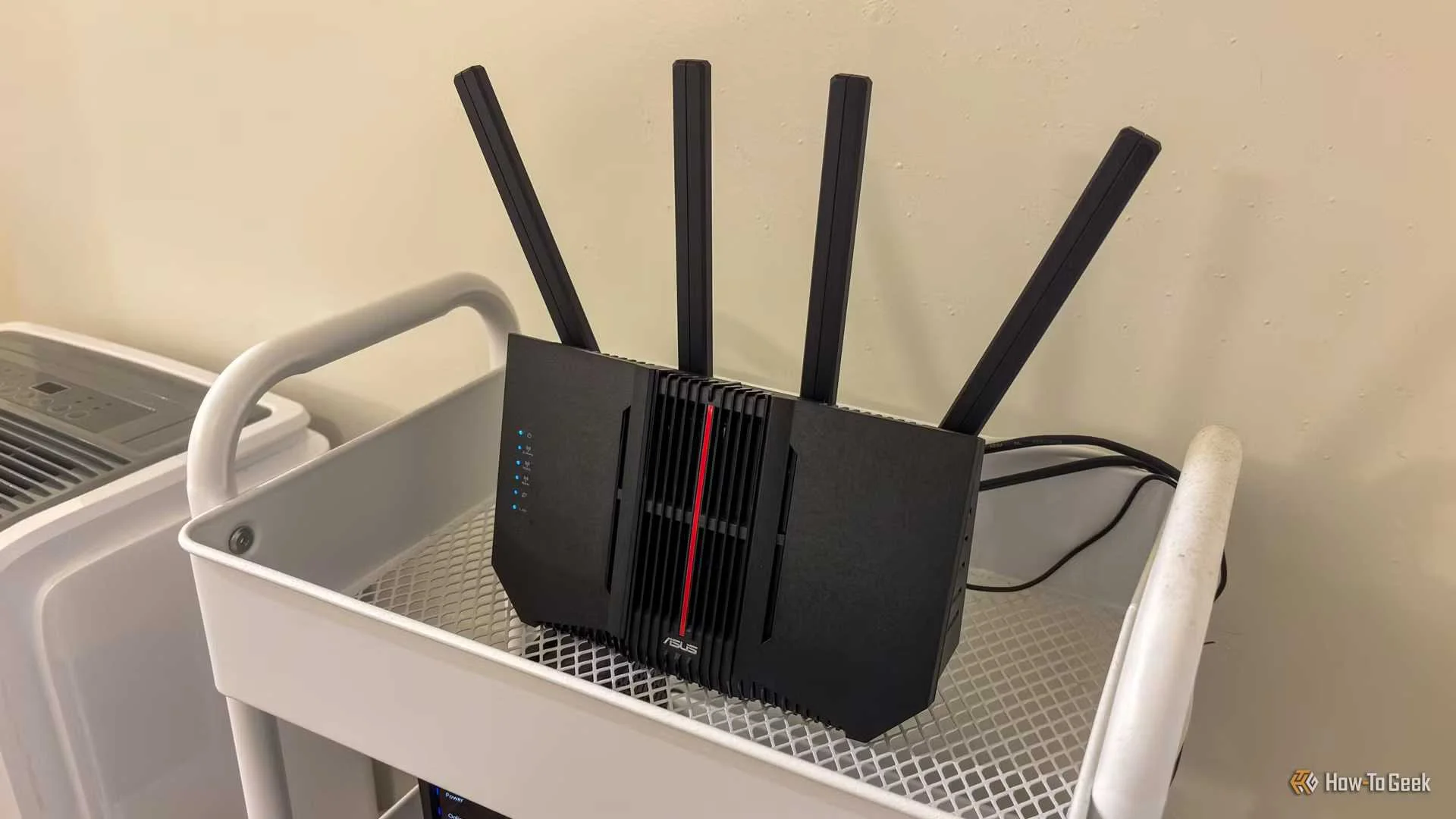 An Asus router on a shelf.