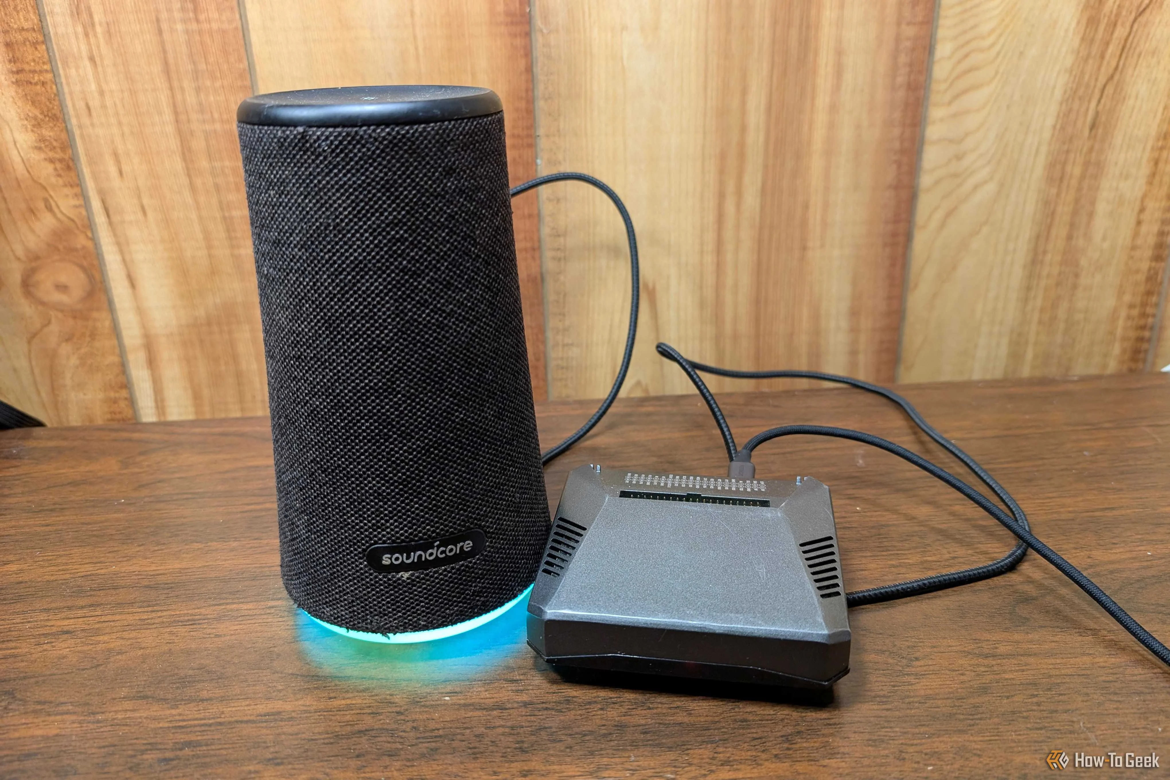A Rapsberry Pi with a speaker next to it. 